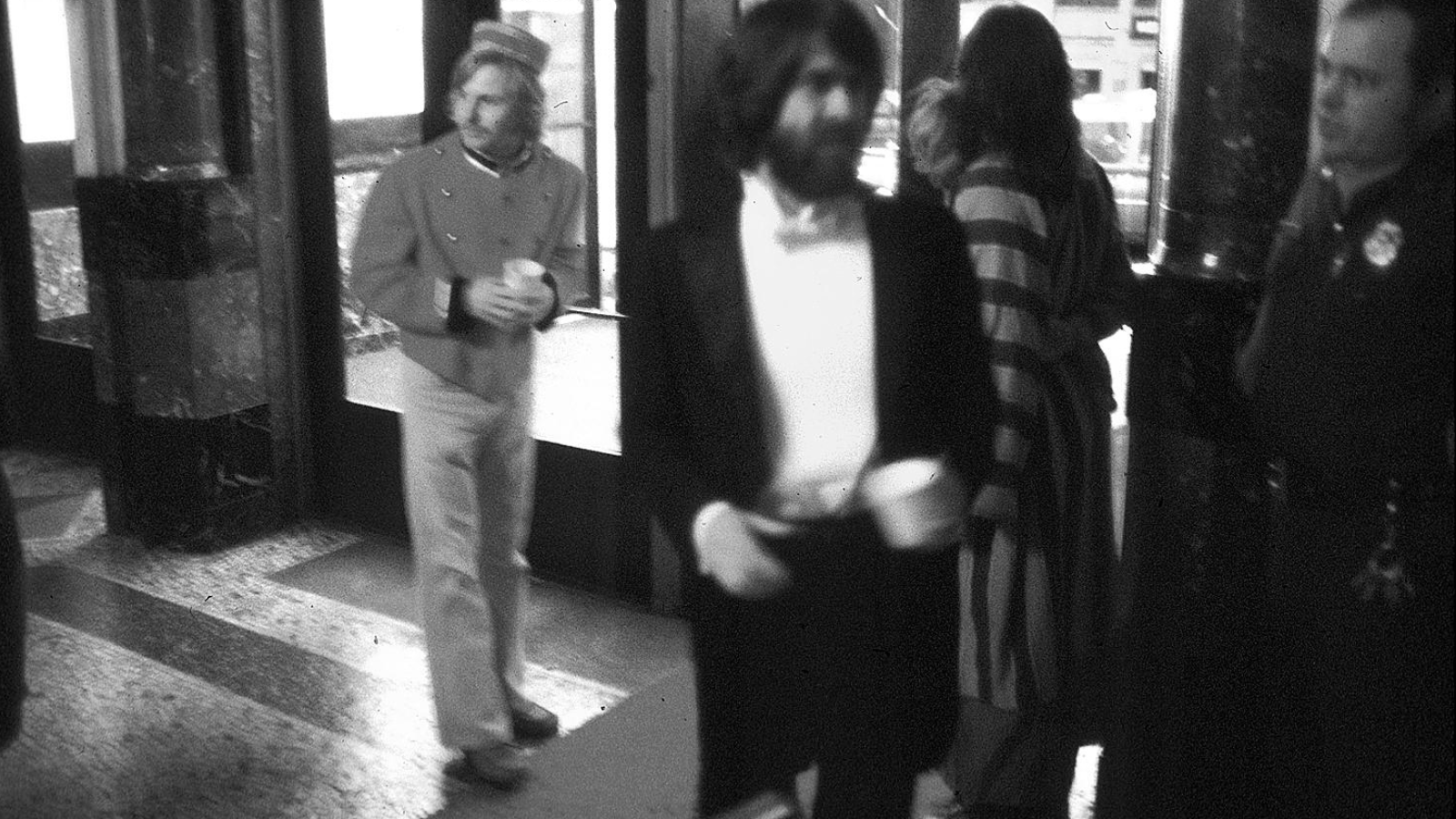 A guest, blurry but dressed to the nines, entering the Moore Egyptian