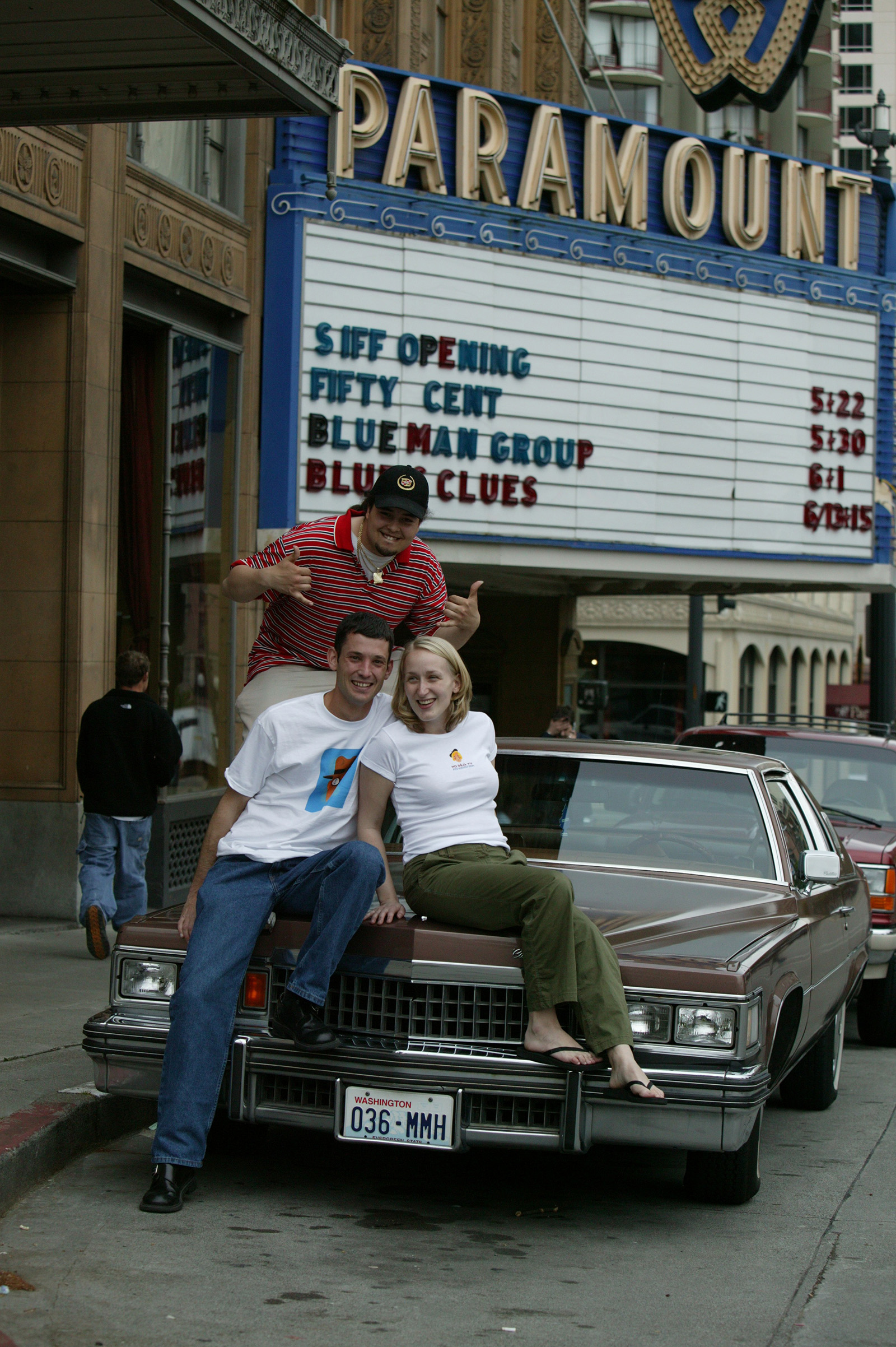 2003 festival merch being modeled from the hood of a car in front of the Paramount Theatre marquee, sure! Why not?