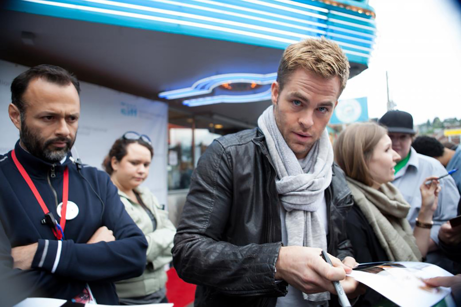 Actor, Chris Pine, in town for his film, People Like Us, looks up from signing autographs outside SIFF Cinema Uptown