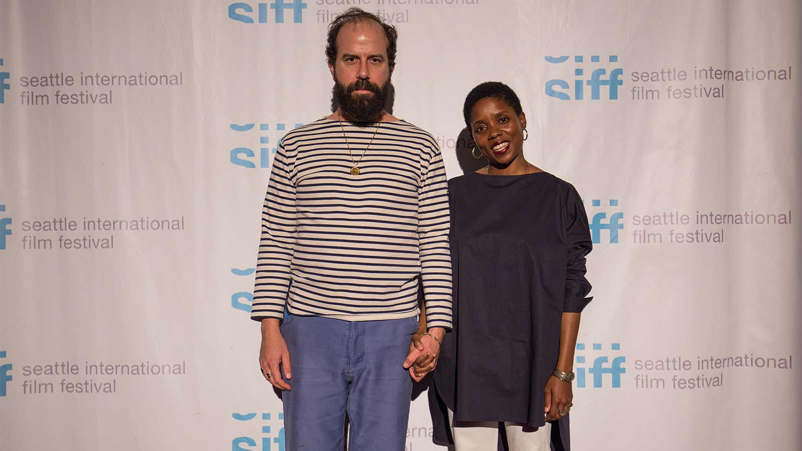 Actor, Brett Gelman, and director, Janicza Bravo, hold hands on the red carpet at the Egyptian for the screening of their film, Lemon