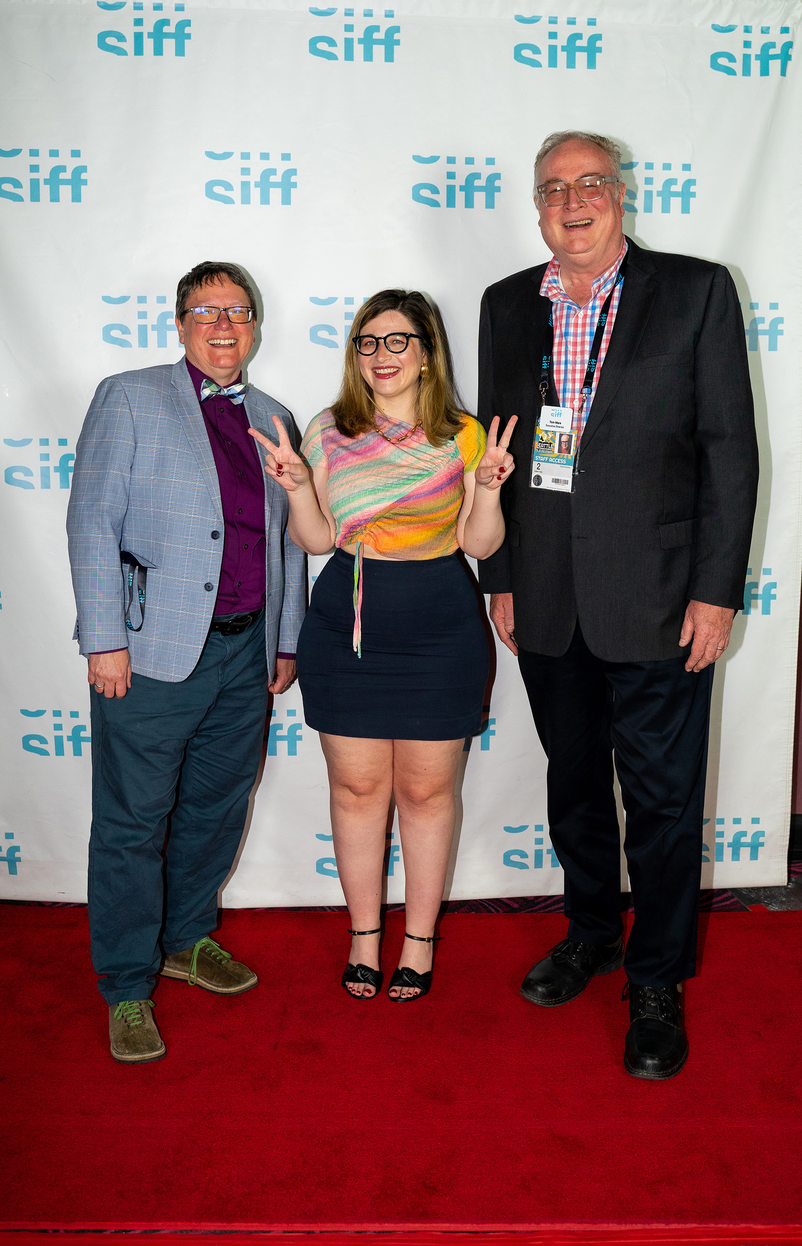 SIFF's Beth Barrett and Tom Mara pose with director, Chandler Levack, on the red carpet at Closing Night, which featured Levack's film I Like Movies